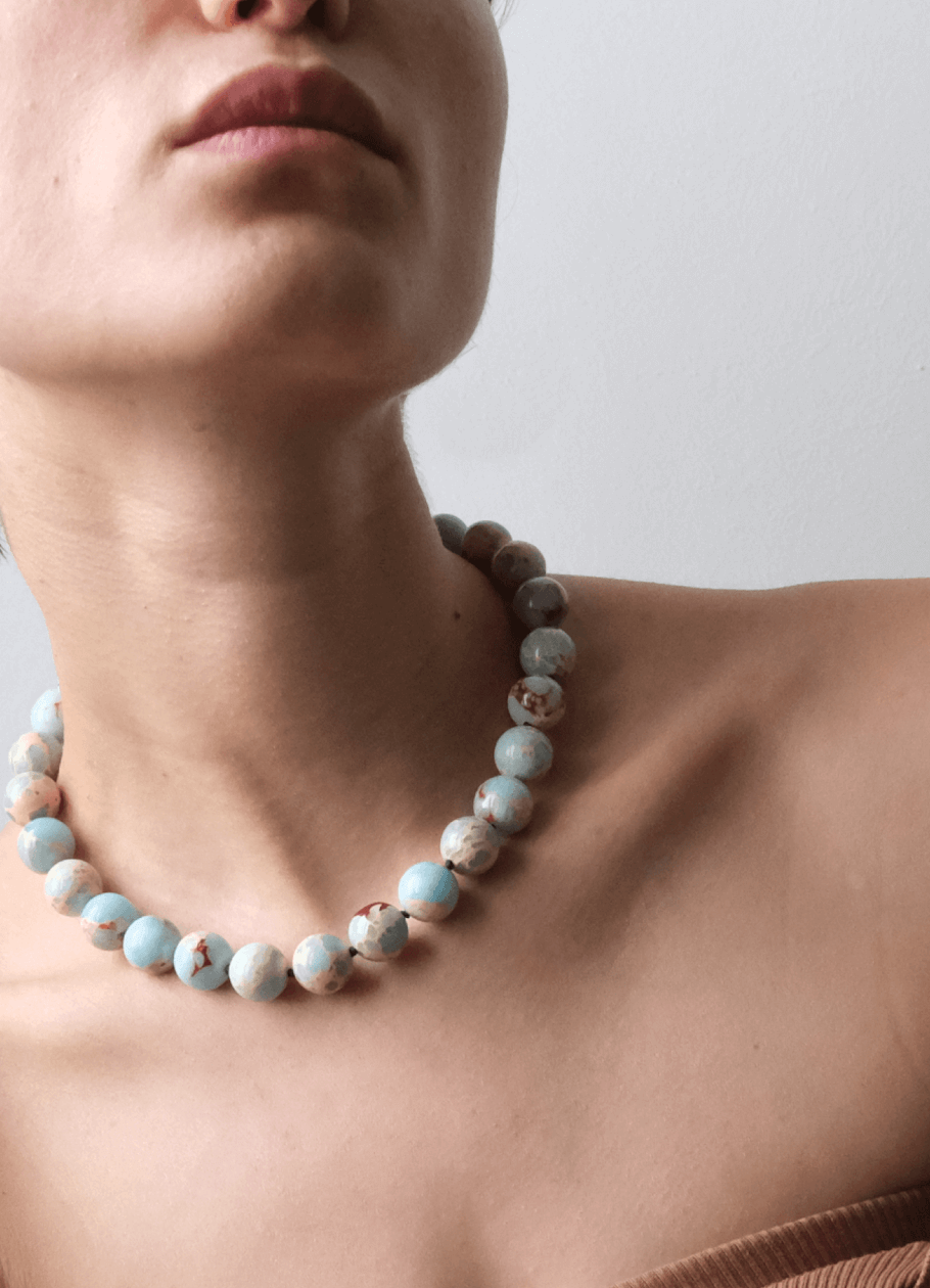 beautiful neckline Wearing a blue gemstone necklace 